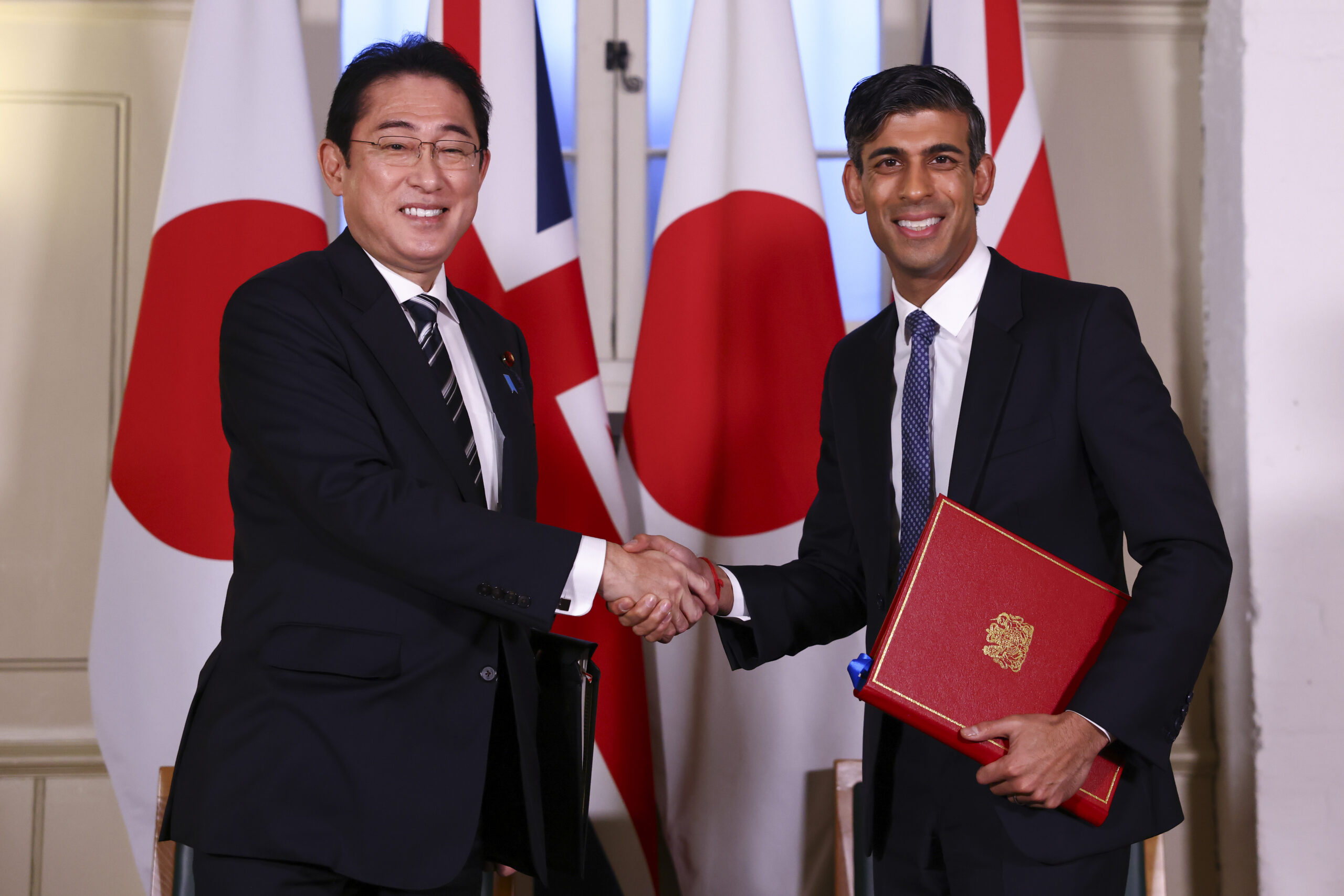 Former Prime Minister Rishi Sunak shaking hands with Japan's Prime Minster Fumio Kishida